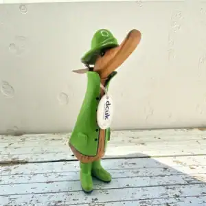 Handcarved bamboo root duck sculpture with green raincoat and hat.